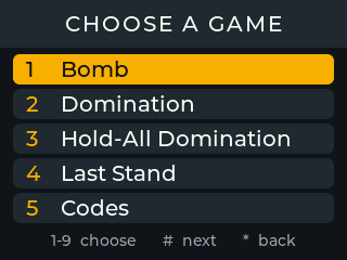 Ecrã da Field Box: cabeçalho «CHOOSE A GAME» com a lista 1 «Bomb» (destacada a amarelo), 2 «Domination», 3 «Hold-All Domination», 4 «Last Stand» e 5 «Codes», e a indicação «1-9 choose # next * back».